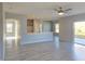 Open-concept space highlighting wood-look floors, light walls, and easy access to outdoor patio at 511 Elbridge Pl, Kissimmee, FL 34758