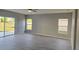 Light-filled living room with wood-look floors and large windows overlooking the backyard at 511 Elbridge Pl, Kissimmee, FL 34758
