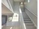 Bright foyer staircase with carpeted steps, modern railing, and beautiful natural light at 511 Elbridge Pl, Kissimmee, FL 34758
