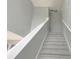 Carpeted staircase with white railing leads to the upper level at 511 Elbridge Pl, Kissimmee, FL 34758