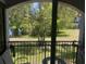 A cozy balcony featuring green space and wrought-iron railing offering relaxing outdoor space at 5501 G Nw Ave # 4714, Orlando, FL 32815