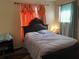 A cozy bedroom with a large window for natural light featuring a comfortable bed and nightstand at 5501 G Nw Ave # 4714, Orlando, FL 32815