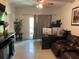 The living room features tile floors and a sliding glass door for ample natural light and outdoor access at 5501 G Nw Ave # 4714, Orlando, FL 32815