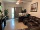 The living room features tile floors and a sliding glass door for ample natural light and outdoor access at 5501 G Nw Ave # 4714, Orlando, FL 32815