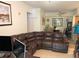 A modern-styled living room with neutral walls, tile flooring, and a cozy leather sectional couch at 5501 G Nw Ave # 4714, Orlando, FL 32815