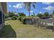 View of the grassy backyard with a chicken coop, offering a blend of nature and functionality at 5572 Myakka Ave, Intercession City, FL 33848
