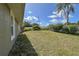 Spacious backyard featuring lush grass and mature landscaping, perfect for outdoor activities and relaxation at 5572 Myakka Ave, Intercession City, FL 33848