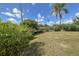 Lush backyard featuring a spacious grassy area, and mature plants, providing a peaceful outdoor retreat at 5572 Myakka Ave, Intercession City, FL 33848