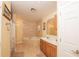 Bathroom boasting a tiled soaking tub, double vanity, and neutral tones at 5572 Myakka Ave, Intercession City, FL 33848