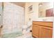 Cozy bathroom including a bathtub with a shower curtain and a vanity with wooden cabinets at 5572 Myakka Ave, Intercession City, FL 33848
