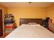 Bedroom with wood floors features a ceiling fan and a bed with storage underneath. There are suitcases stacked near the door at 5572 Myakka Ave, Intercession City, FL 33848