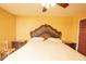 Bedroom featuring a beautifully carved headboard, and bedside tables at 5572 Myakka Ave, Intercession City, FL 33848