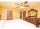 Bedroom featuring a vanity, large bed, and open doorway at 5572 Myakka Ave, Intercession City, FL 33848