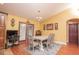 Dining room with hardwood floors and chandelier lighting adjacent to the kitchen and back door at 5572 Myakka Ave, Intercession City, FL 33848