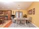 Dining room with hardwood floors and chandelier lighting is located right off the kitchen at 5572 Myakka Ave, Intercession City, FL 33848