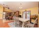 Bright dining area with chandelier lighting adjoins the kitchen, features hardwood floors and an aquarium at 5572 Myakka Ave, Intercession City, FL 33848