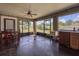 Bright enclosed porch area perfect for dining, featuring large windows and a ceiling fan at 5572 Myakka Ave, Intercession City, FL 33848