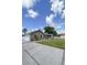 Well-maintained home with a spacious driveway, attached garage, and manicured front lawn at 5572 Myakka Ave, Intercession City, FL 33848