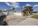 Charming single-Gathering home featuring a detached garage, spacious driveway, and well-maintained landscaping at 5572 Myakka Ave, Intercession City, FL 33848