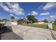 Charming single-story home with a well-maintained lawn, detached garage, and a classic white picket fence at 5572 Myakka Ave, Intercession City, FL 33848