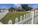 Charming single-story home with a well-maintained lawn, detached garage, and a classic white picket fence at 5572 Myakka Ave, Intercession City, FL 33848