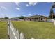 Charming single-story home with a well-maintained lawn and classic white picket fence, offering privacy at 5572 Myakka Ave, Intercession City, FL 33848
