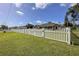 Charming single-story home with a well-maintained lawn and classic white picket fence, offering privacy at 5572 Myakka Ave, Intercession City, FL 33848