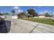 Charming single-story home with a well-manicured lawn, garage, and ample parking on a sunny day at 5572 Myakka Ave, Intercession City, FL 33848