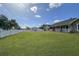 Expansive and well-manicured front lawn enclosed by a classic white picket fence, enhancing curb appeal at 5572 Myakka Ave, Intercession City, FL 33848