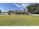 Well-maintained lawn leading up to a charming house with a covered front porch at 5572 Myakka Ave, Intercession City, FL 33848