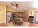Updated kitchen features stainless steel appliances, granite counters, island with bar seating, and hardwood floors at 5572 Myakka Ave, Intercession City, FL 33848