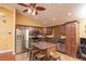 Kitchen with granite counters features stainless steel appliances, a breakfast bar, and wood cabinets at 5572 Myakka Ave, Intercession City, FL 33848