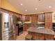 Updated kitchen featuring stainless steel appliances, granite counters, and breakfast bar seating at the island at 5572 Myakka Ave, Intercession City, FL 33848