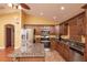 Kitchen with granite counters features stainless steel appliances, a breakfast bar, and wood cabinets at 5572 Myakka Ave, Intercession City, FL 33848