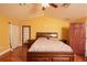 Spacious main bedroom with laminate flooring, vaulted ceiling, and ensuite bathroom at 5572 Myakka Ave, Intercession City, FL 33848