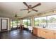 Enclosed sunroom features a table and chairs, a ceiling fan, plus a utility sink and cabinets at 5572 Myakka Ave, Intercession City, FL 33848