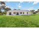 Well-maintained backyard and patio featuring a lush green lawn and ample space for outdoor activities and relaxation at 5919 Mcenroe Ct, Leesburg, FL 34748