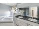 Bathroom featuring dual sinks with granite countertops, a soaking tub, and a shower, creating a spa-like retreat at 5919 Mcenroe Ct, Leesburg, FL 34748