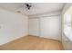 Bedroom featuring a ceiling fan, closet doors, and a window at 5919 Mcenroe Ct, Leesburg, FL 34748