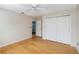 Bedroom featuring hardwood floors, closet doors, and a ceiling fan at 5919 Mcenroe Ct, Leesburg, FL 34748