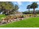 Beautiful Highland Lakes community entrance with stone accents, fountain and landscaping at 5919 Mcenroe Ct, Leesburg, FL 34748