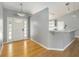 Welcoming foyer featuring hardwood floors and views into the kitchen at 5919 Mcenroe Ct, Leesburg, FL 34748