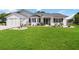 Beautiful single-Gathering home featuring a lush green lawn and attached garage at 5919 Mcenroe Ct, Leesburg, FL 34748