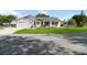 Inviting single-level home with an attached garage and meticulously maintained landscaping at 5919 Mcenroe Ct, Leesburg, FL 34748