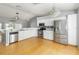Modern kitchen with stainless steel appliances, sleek countertops, and hardwood flooring at 5919 Mcenroe Ct, Leesburg, FL 34748