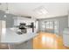Open kitchen with stainless steel appliances, a breakfast bar and a dining area with natural light at 5919 Mcenroe Ct, Leesburg, FL 34748