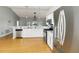 Bright kitchen features stainless steel appliances and white cabinetry at 5919 Mcenroe Ct, Leesburg, FL 34748