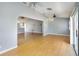 Spacious living room showing the open floor plan to the kitchen and hardwood flooring at 5919 Mcenroe Ct, Leesburg, FL 34748