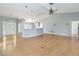 Open concept living room showcasing the breakfast bar, hardwood floors, and stylish lighting at 5919 Mcenroe Ct, Leesburg, FL 34748