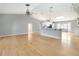 Bright living room with vaulted ceilings open to the modern kitchen and adjacent breakfast area at 5919 Mcenroe Ct, Leesburg, FL 34748